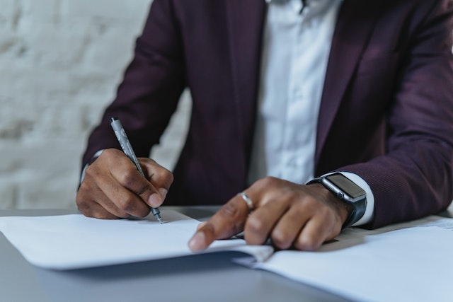 A landlord in a dark purple blazer reviews evidence prior to taking their tenant to small claims court